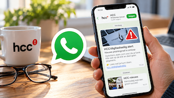 Smartphone met op scherm HCC kanaal op whatsapp
