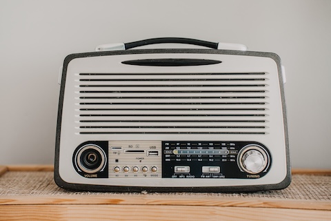 Old fashion radio on cabinet. Retro stuff, Nostalgia concept. Old things, electronics. Vintage radio receiver.