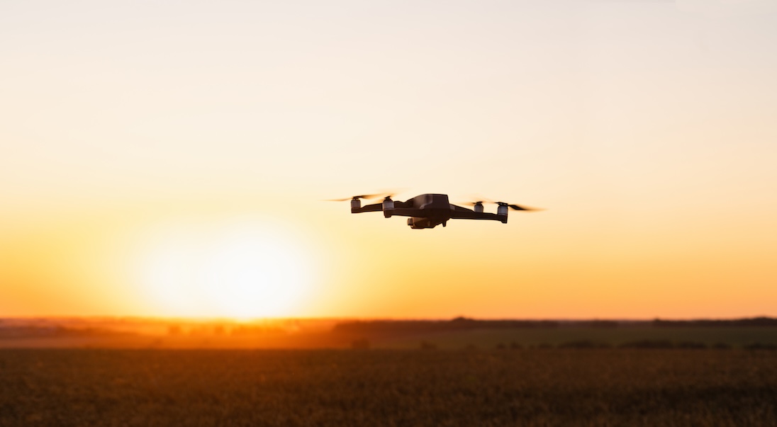 Drone die vliegt en een zonsondergang